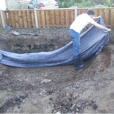 Installing a pond liner underlay